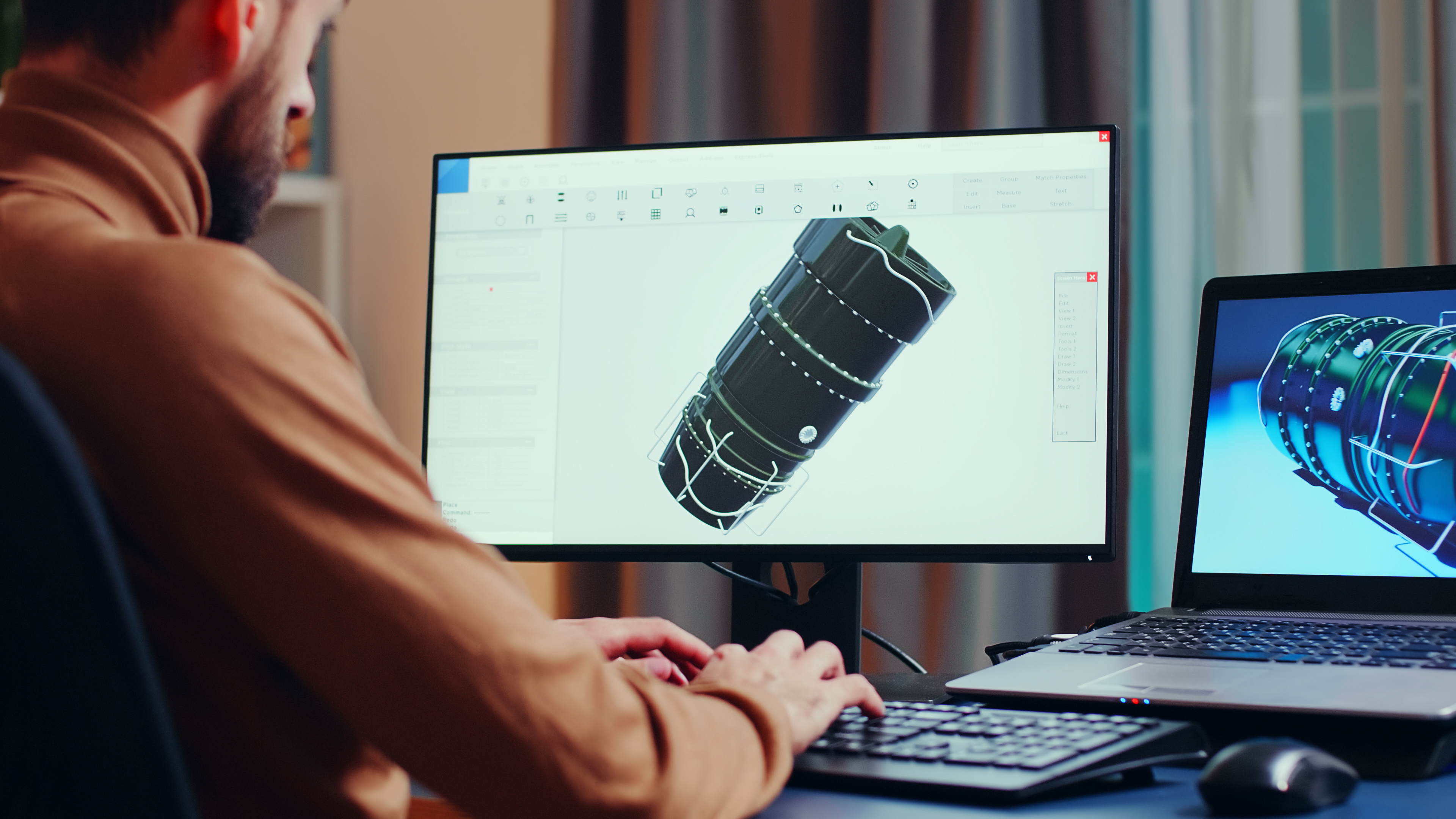Smiling woman with braided hair sitting at a desk with a computer, looking to the side.
